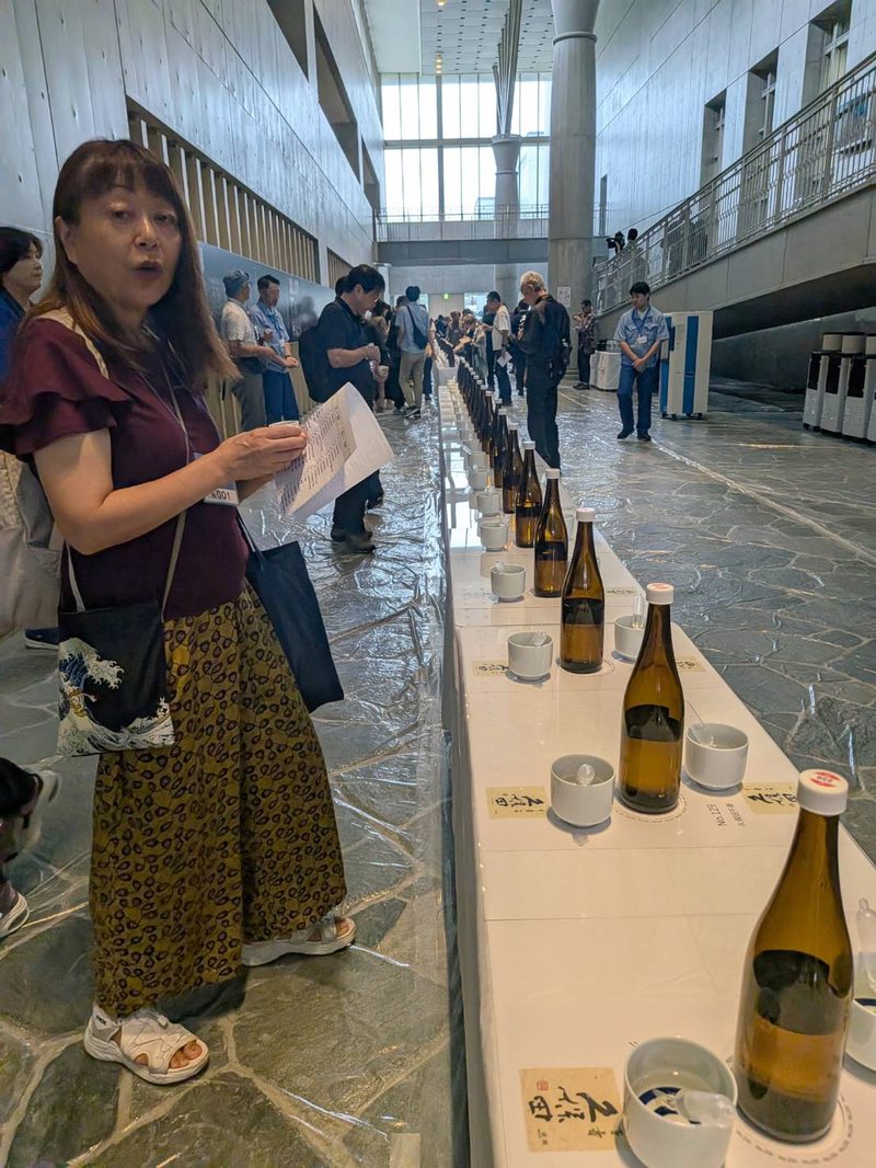 Miyuki at a tasting counter at the Asahi Shuzo sake brewery