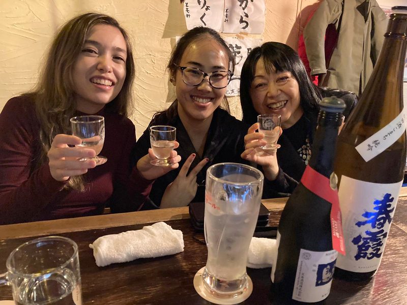 Toasting with local sake at an izakaya