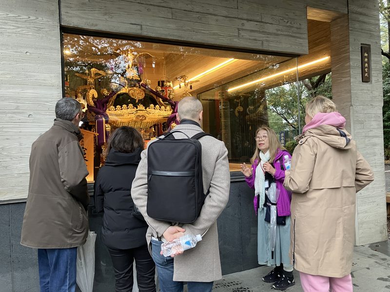 Guests looking at a portable shrine kept behind glass