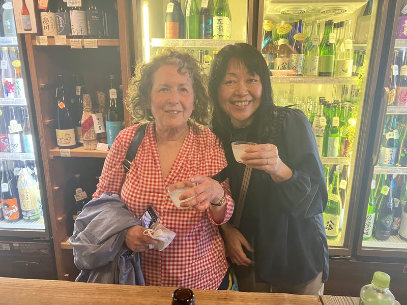 A guest and her guide at a sake shop in Monzen-Nakacho