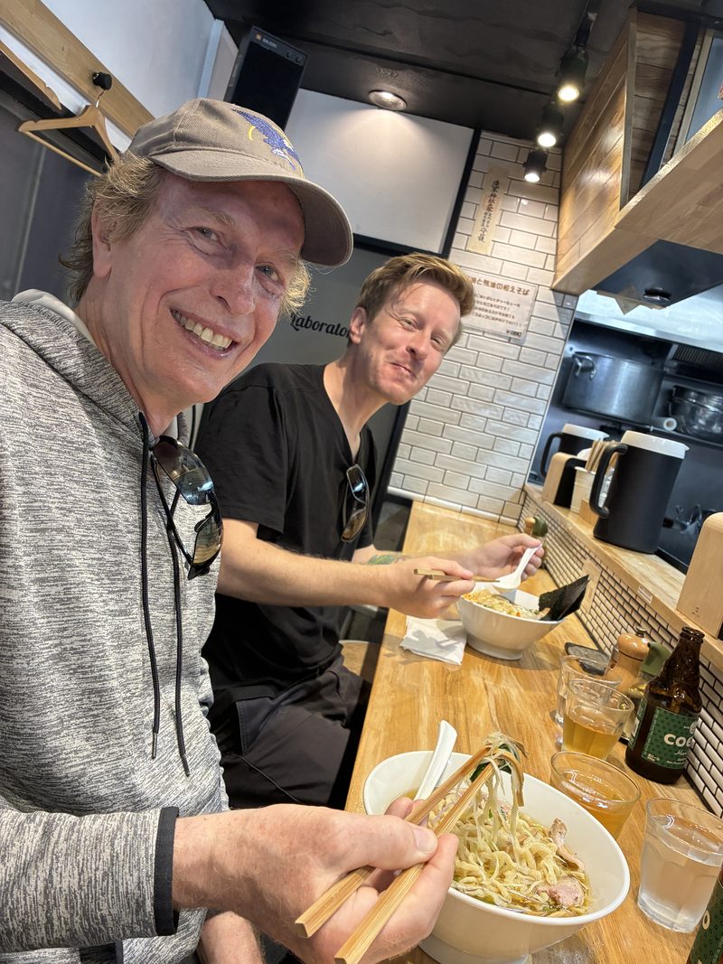 Guests slurping ramen at a counter