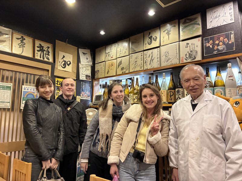 Guests with the owner of a long-established restaurant