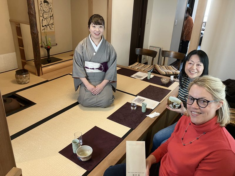 A tea gathering in a tatami room, hosted by a woman in kimono